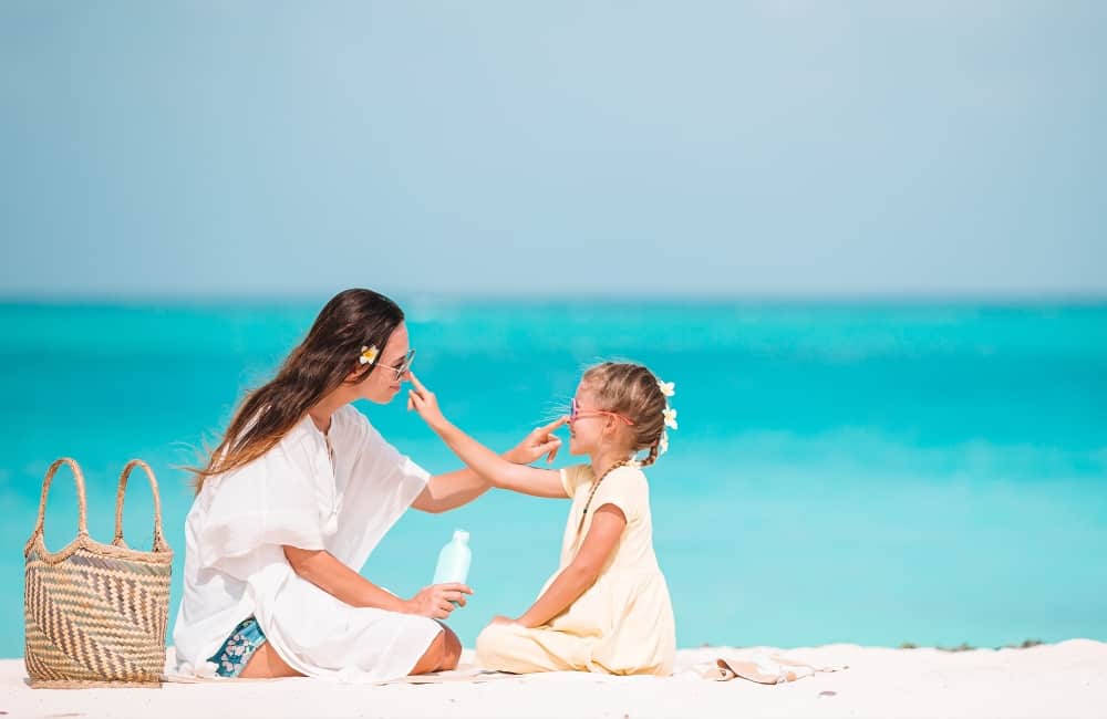 mother and child enjoying sunny beach